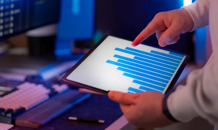 Professional analysing a chart on a tablet in an office