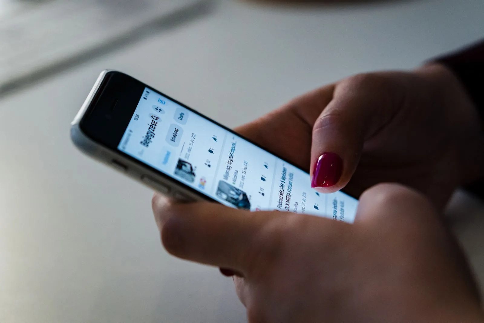 Scrolling a feed on a smartphone — where most job seekers meet ghost listings