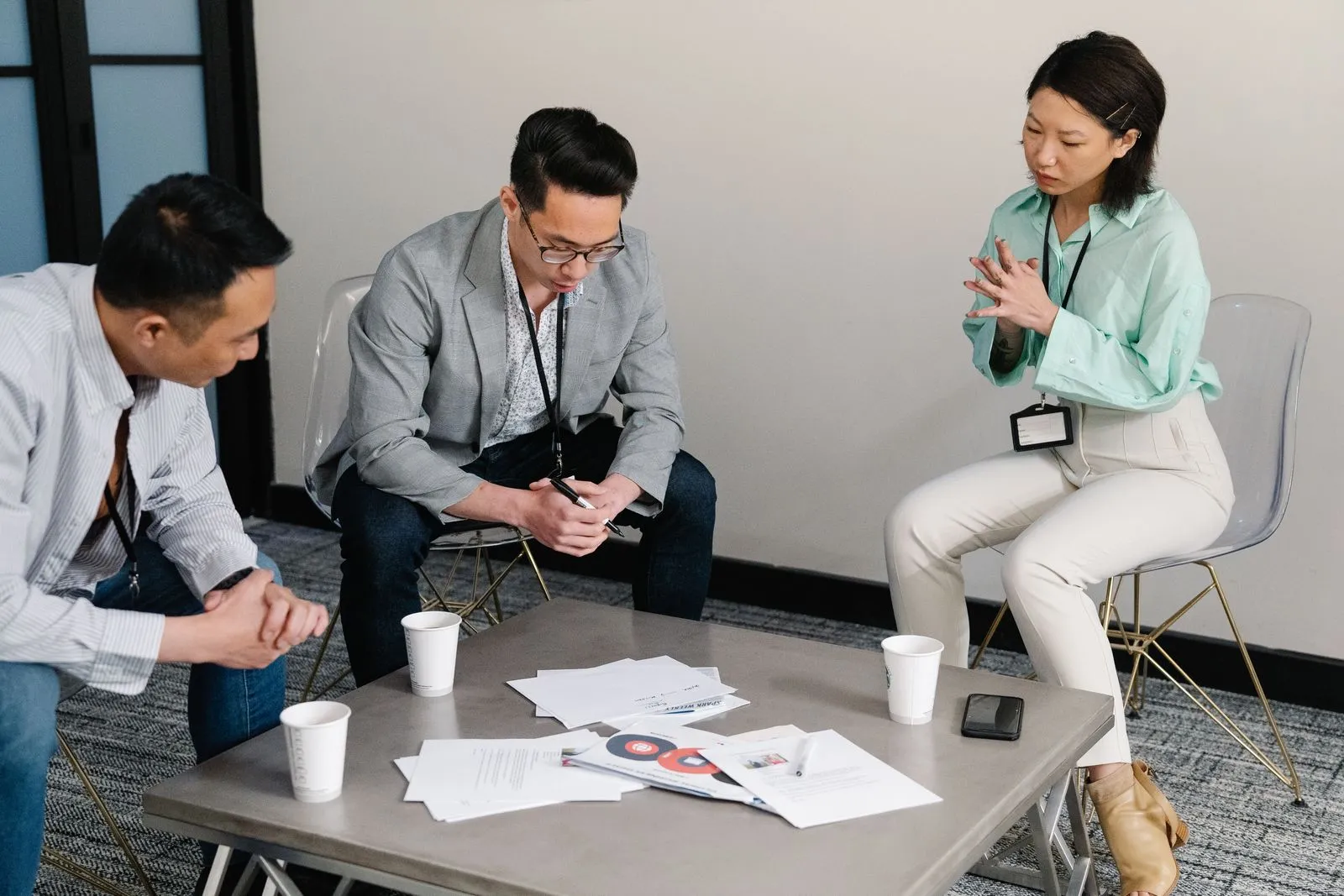 Colleagues reviewing documents in an office — internal hiring decisions that never reach a job board