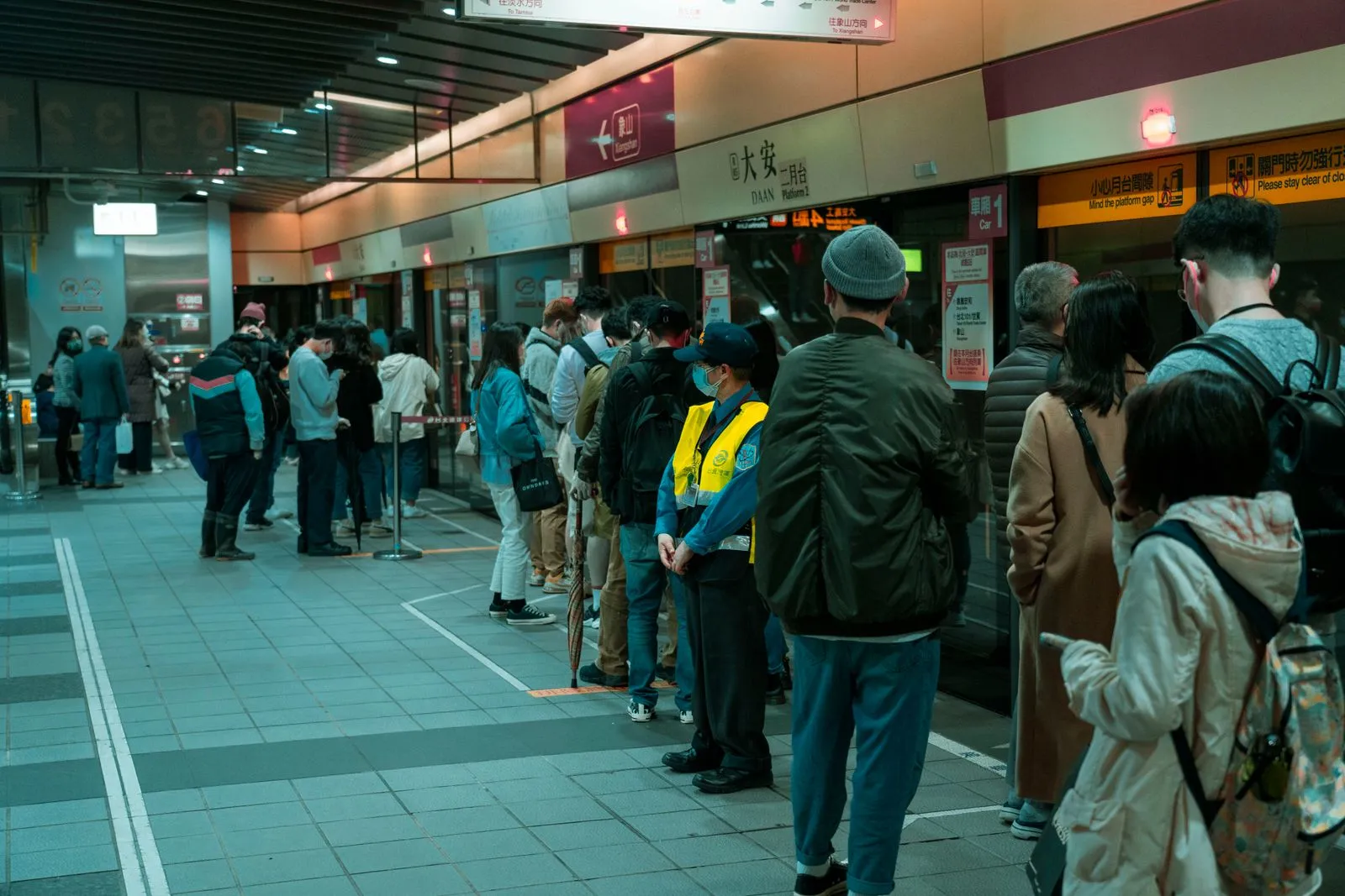 Commuters queuing on a station platform — visibility, not merit, determines the length of the line