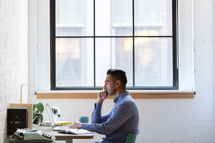 Focused professional applying to a job on a laptop