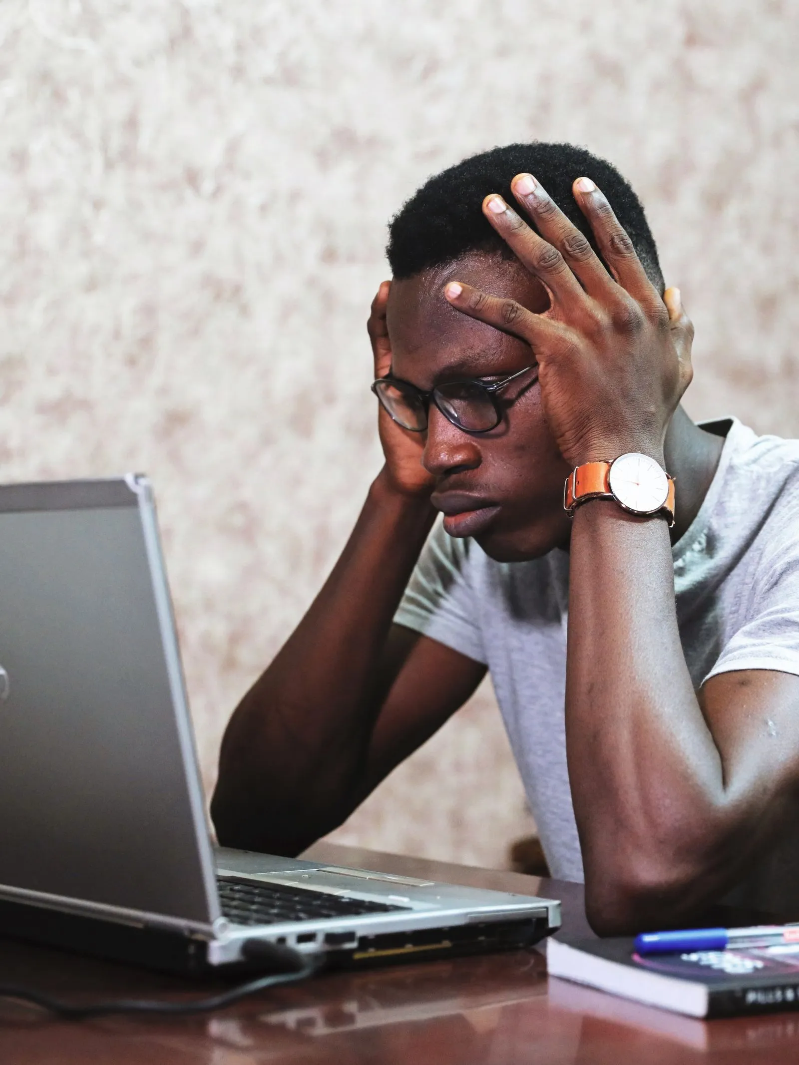 Frustrated job seeker at a laptop — silence after applying is usually structural, not personal
