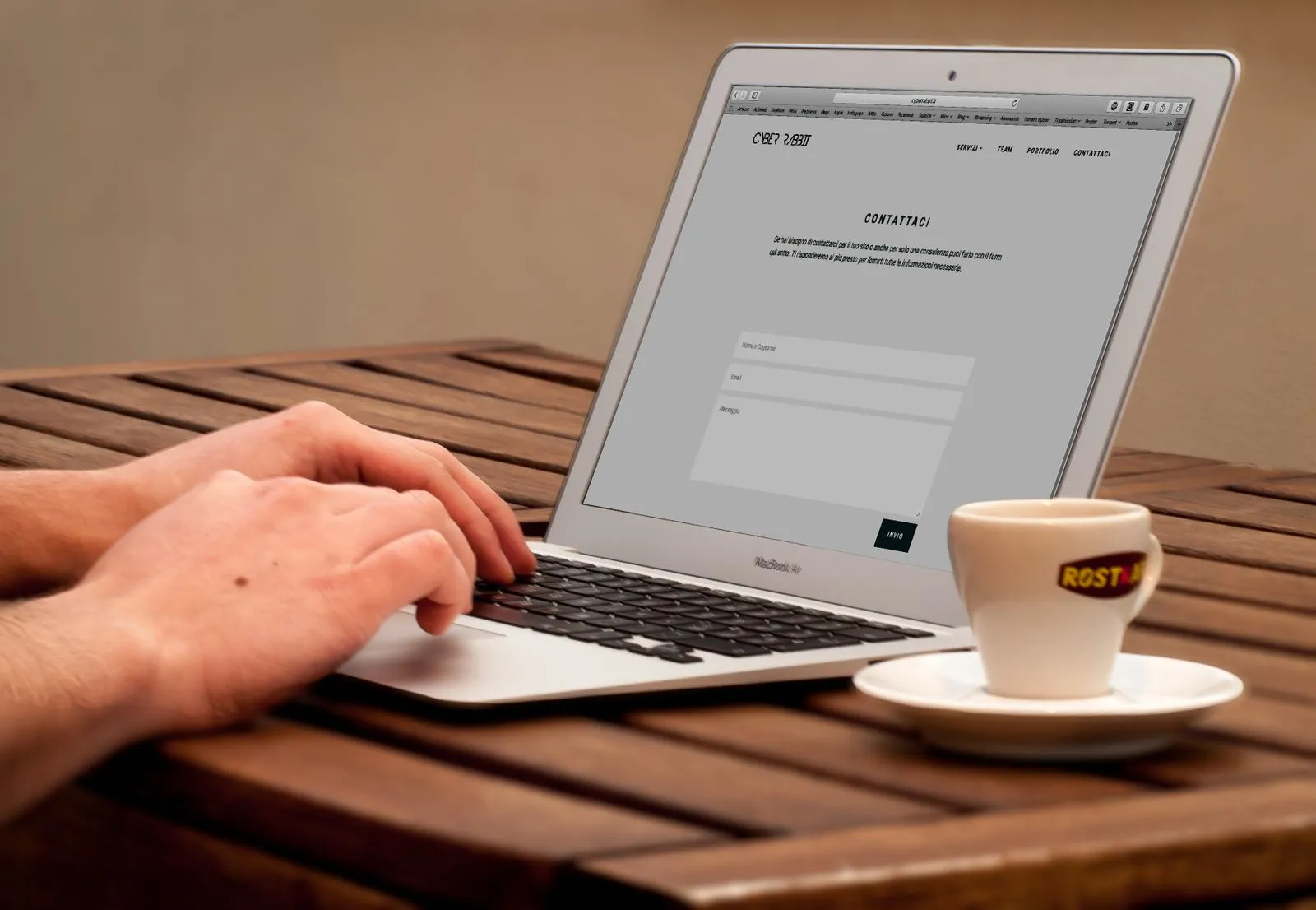 Hands typing on a laptop beside a coffee — checking careers pages directly takes seconds once you know where to look