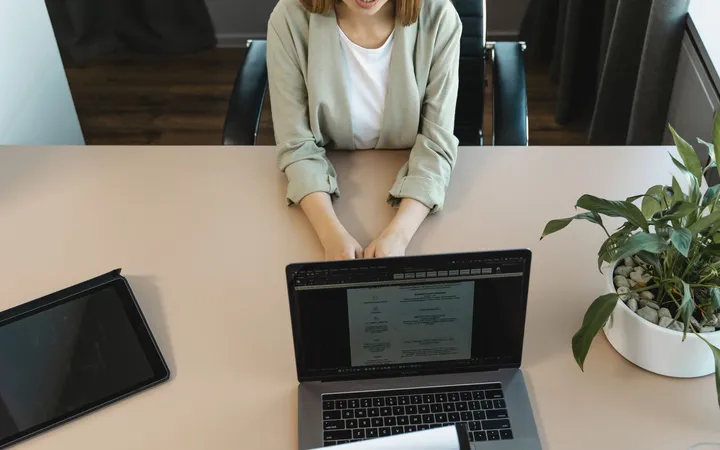 A job interview across a desk in a modern office
