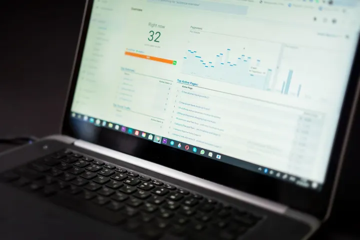 Analytics dashboard on a laptop showing charts and data trends