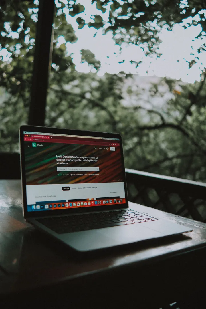 Laptop on a desk showing a company website