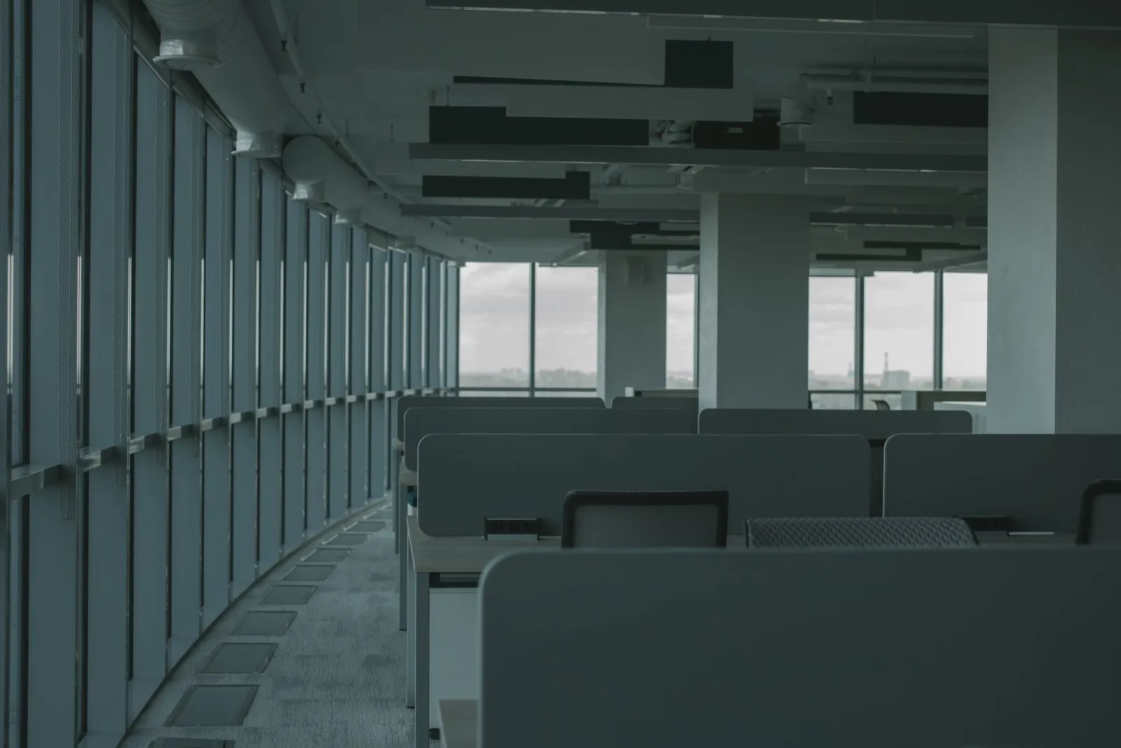 A modern office with empty desks — openings advertised, nobody actually hiring