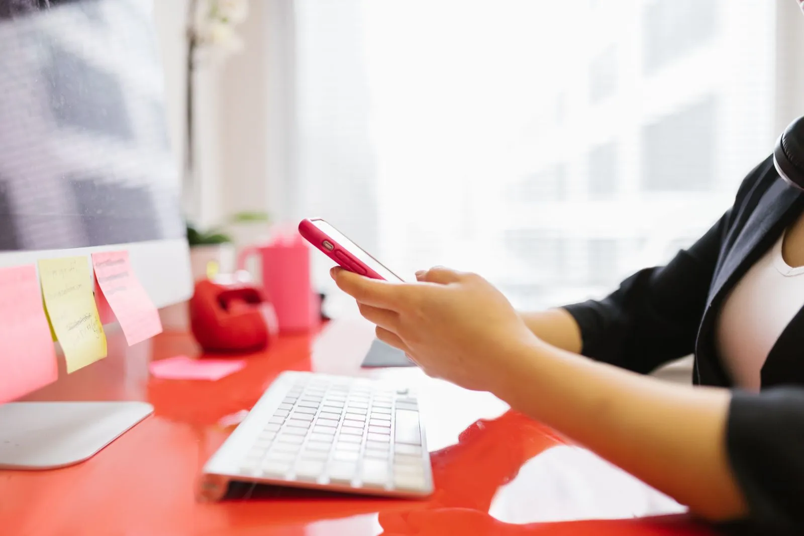 Professional checking their phone at a workstation — the applicant count is data, even when you don't apply