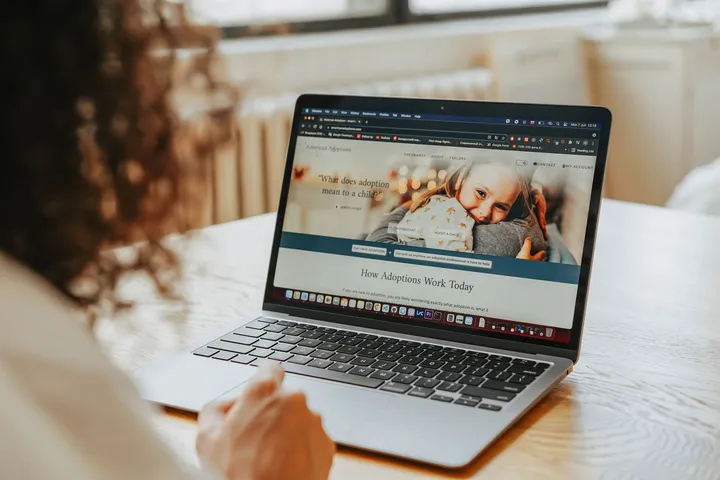 Person researching companies and open roles on a laptop